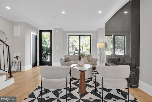 living area with stairway, light wood finished floors, baseboards, and recessed lighting