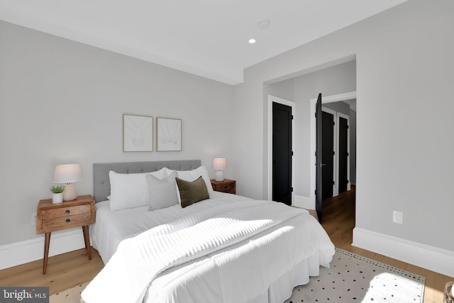 bedroom with baseboards, recessed lighting, and wood finished floors