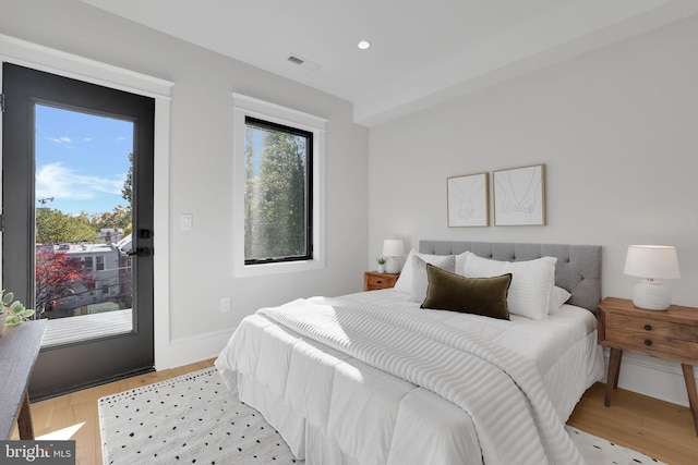 bedroom featuring light wood-style floors, visible vents, access to exterior, and recessed lighting