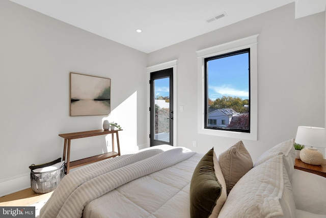 bedroom with recessed lighting, baseboards, visible vents, wood finished floors, and access to exterior