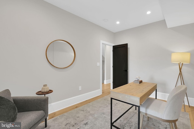 office space featuring light wood finished floors, baseboards, and recessed lighting