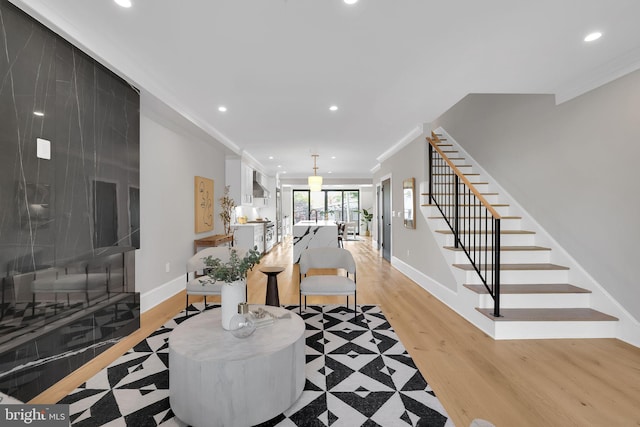 foyer featuring stairs, recessed lighting, crown molding, light wood finished floors, and baseboards