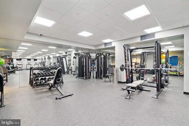 gym featuring a drop ceiling