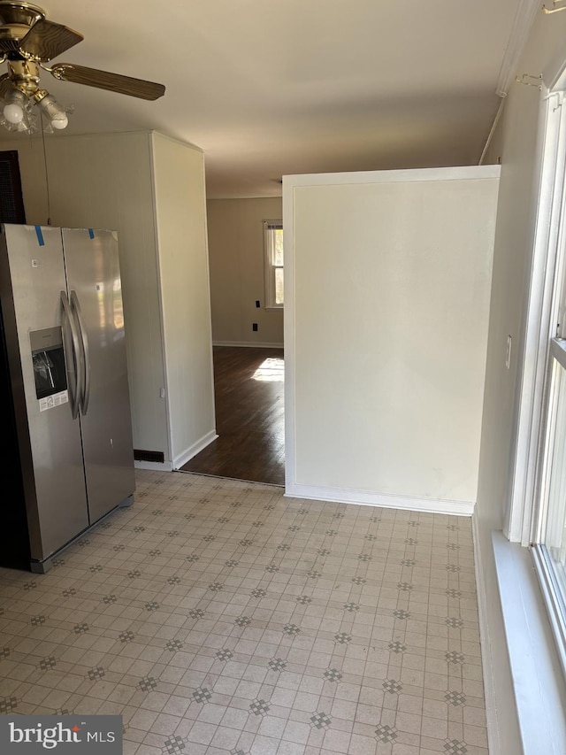 kitchen with crown molding, stainless steel refrigerator with ice dispenser, light wood-type flooring, and ceiling fan