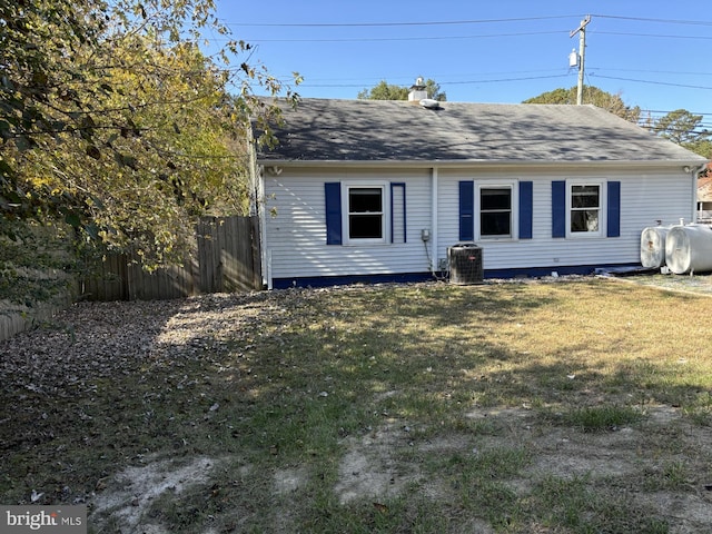 view of front of house featuring a front lawn and central AC unit