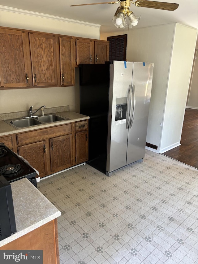 kitchen with ceiling fan, range, light hardwood / wood-style floors, stainless steel refrigerator with ice dispenser, and sink