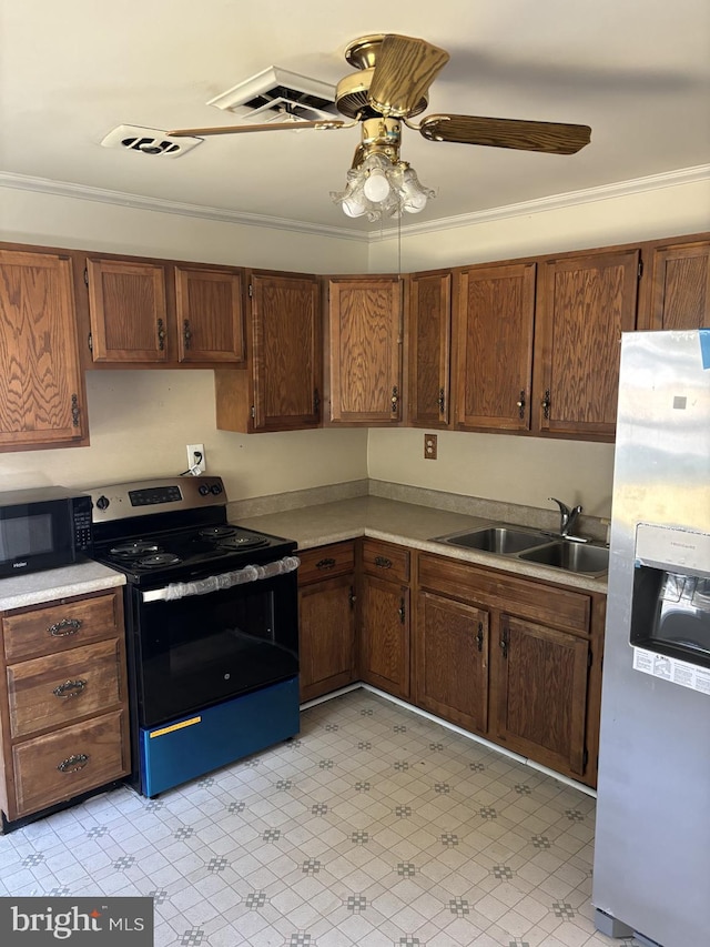 kitchen with ornamental molding, black appliances, sink, and ceiling fan