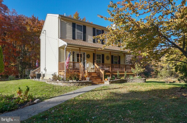 view of front of property with covered porch and a front lawn