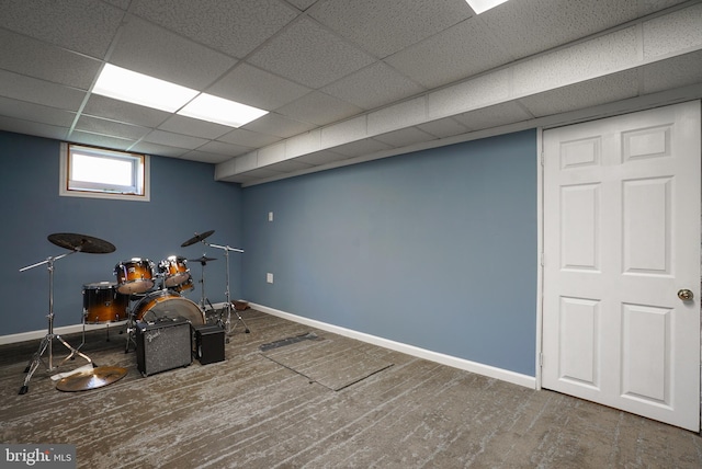 basement with hardwood / wood-style flooring and a paneled ceiling