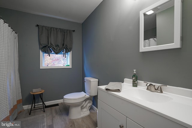 bathroom featuring vanity, toilet, and wood-type flooring