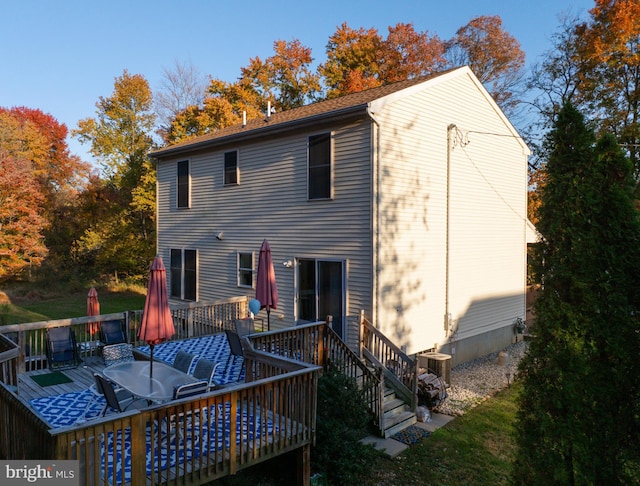 back of house with cooling unit and a deck