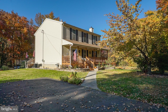 view of property with a front lawn and a porch