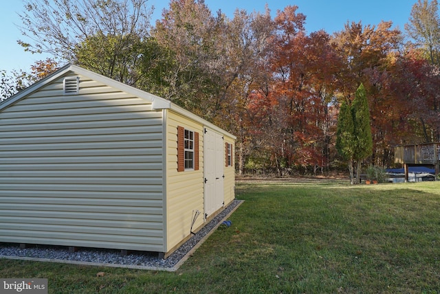 view of outbuilding featuring a lawn