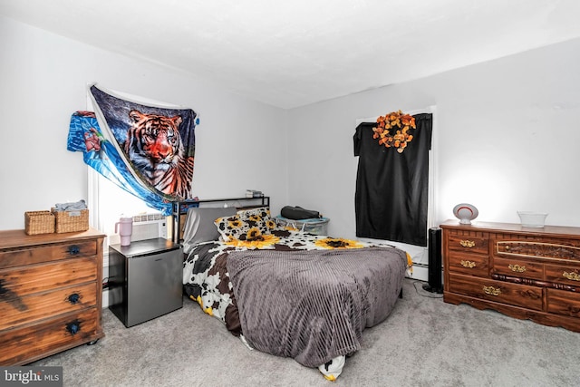 carpeted bedroom featuring a baseboard radiator