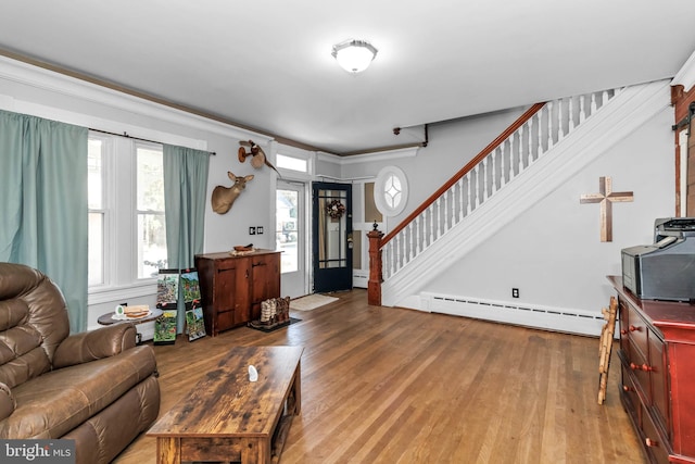 living room featuring baseboard heating and light wood-type flooring