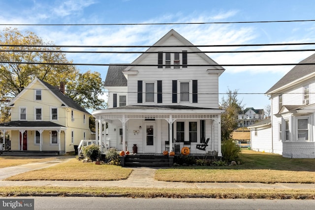 view of front of property with a front lawn and covered porch