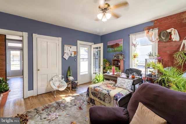 living room featuring light hardwood / wood-style floors, a healthy amount of sunlight, and ceiling fan