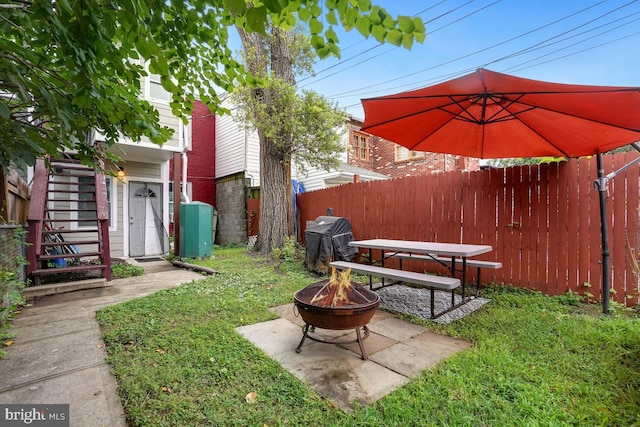 view of yard featuring a patio area and a fire pit