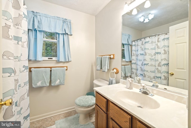 bathroom with vanity, toilet, a textured ceiling, and curtained shower