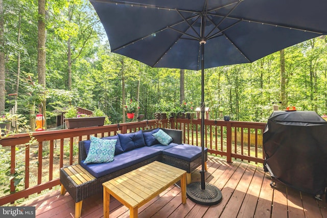 wooden deck featuring a grill