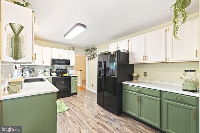 kitchen featuring light hardwood / wood-style floors, black appliances, sink, and white cabinets