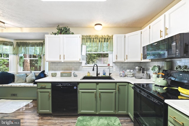 kitchen featuring dark hardwood / wood-style floors, black appliances, sink, and plenty of natural light