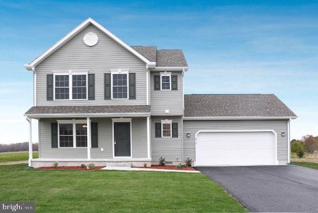 front of property featuring covered porch, a garage, and a front yard