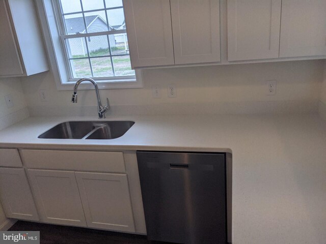 kitchen featuring dishwasher, white cabinets, and sink