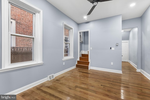 spare room featuring dark hardwood / wood-style flooring and ceiling fan