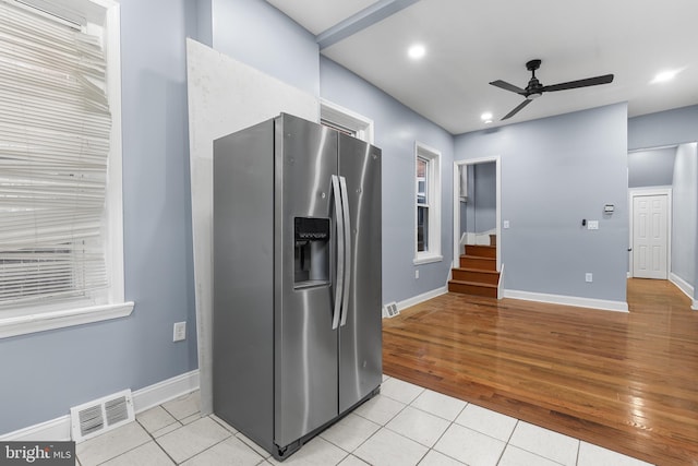 kitchen featuring ceiling fan, stainless steel fridge with ice dispenser, and light wood-type flooring