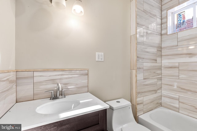 bathroom with toilet, vanity, and a bath