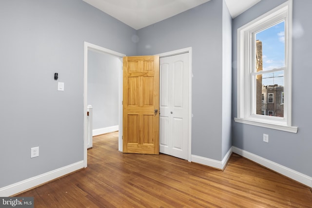 unfurnished bedroom with wood-type flooring