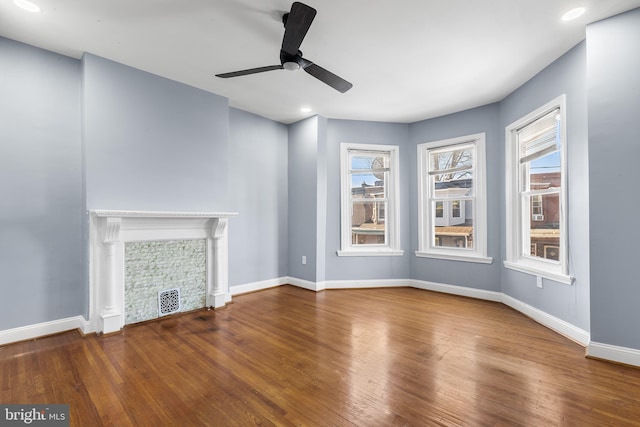 unfurnished living room featuring ceiling fan and wood-type flooring