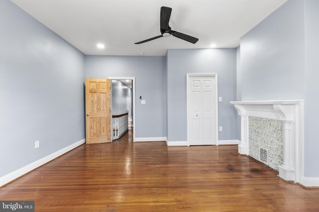 unfurnished living room featuring dark hardwood / wood-style flooring and ceiling fan