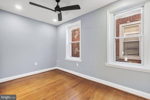 empty room featuring hardwood / wood-style flooring and ceiling fan