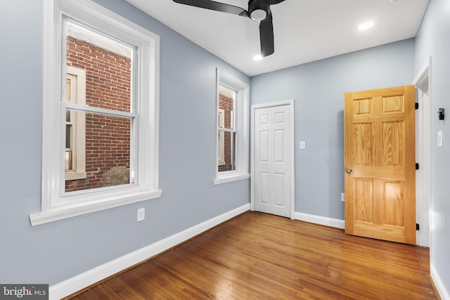 unfurnished room with wood-type flooring and ceiling fan