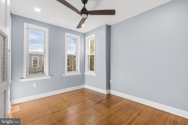 unfurnished room with ceiling fan, wood-type flooring, and a healthy amount of sunlight