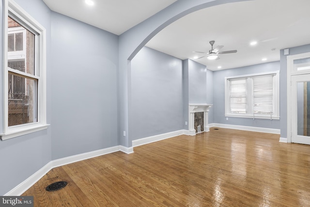 unfurnished living room with hardwood / wood-style flooring and ceiling fan