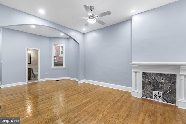 unfurnished living room with hardwood / wood-style floors and ceiling fan