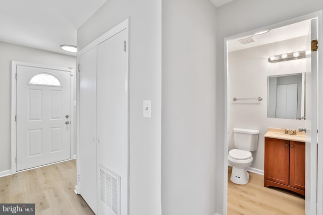 entrance foyer featuring sink and light hardwood / wood-style flooring