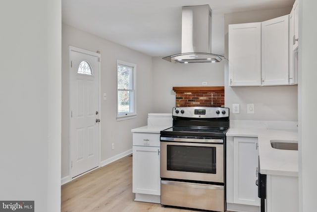 kitchen featuring electric stove, light hardwood / wood-style flooring, white cabinets, and island exhaust hood