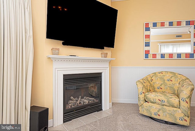 sitting room featuring light colored carpet