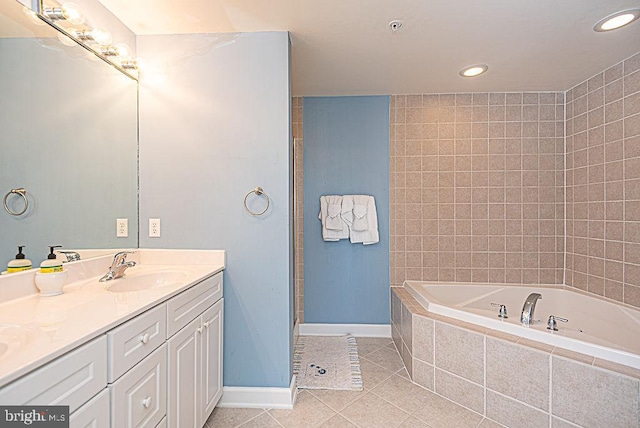 bathroom with vanity, tiled tub, and tile patterned floors