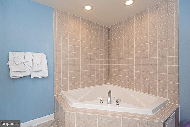 bathroom with a relaxing tiled tub