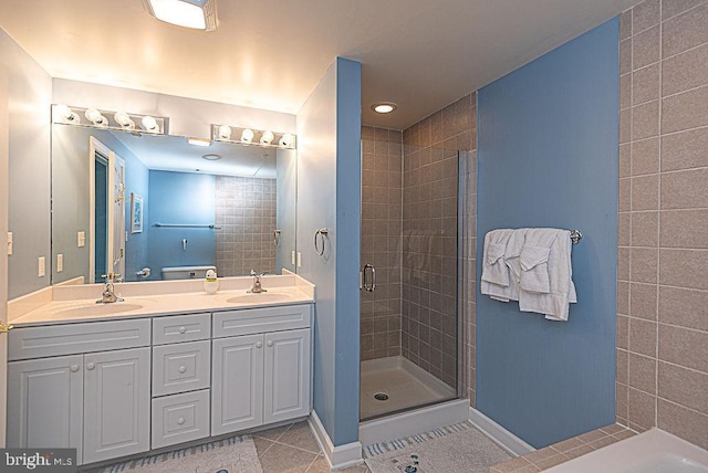 bathroom with vanity, tile patterned flooring, and walk in shower