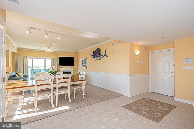 dining space featuring crown molding and ceiling fan