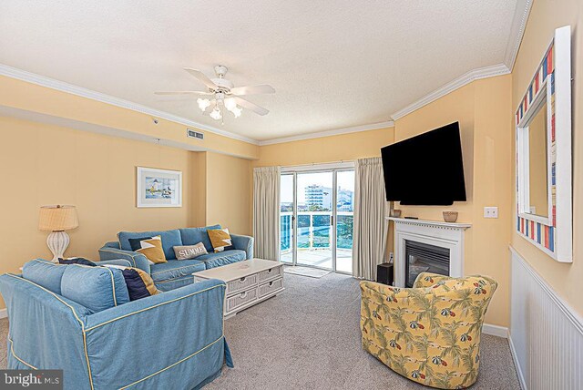 carpeted living room with crown molding, a textured ceiling, and ceiling fan