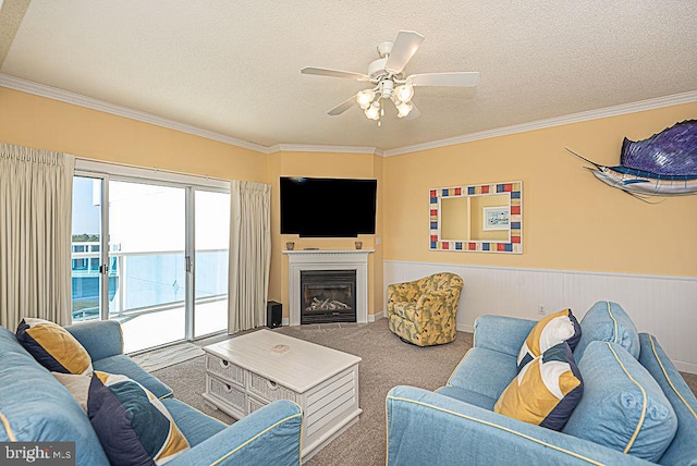 living room featuring crown molding, a textured ceiling, carpet floors, and ceiling fan