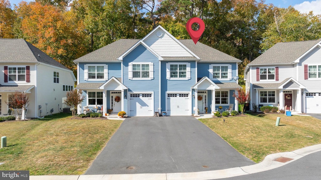 view of front facade featuring a front lawn and a garage