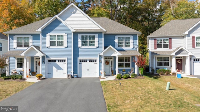 view of front of property with a front lawn and a garage